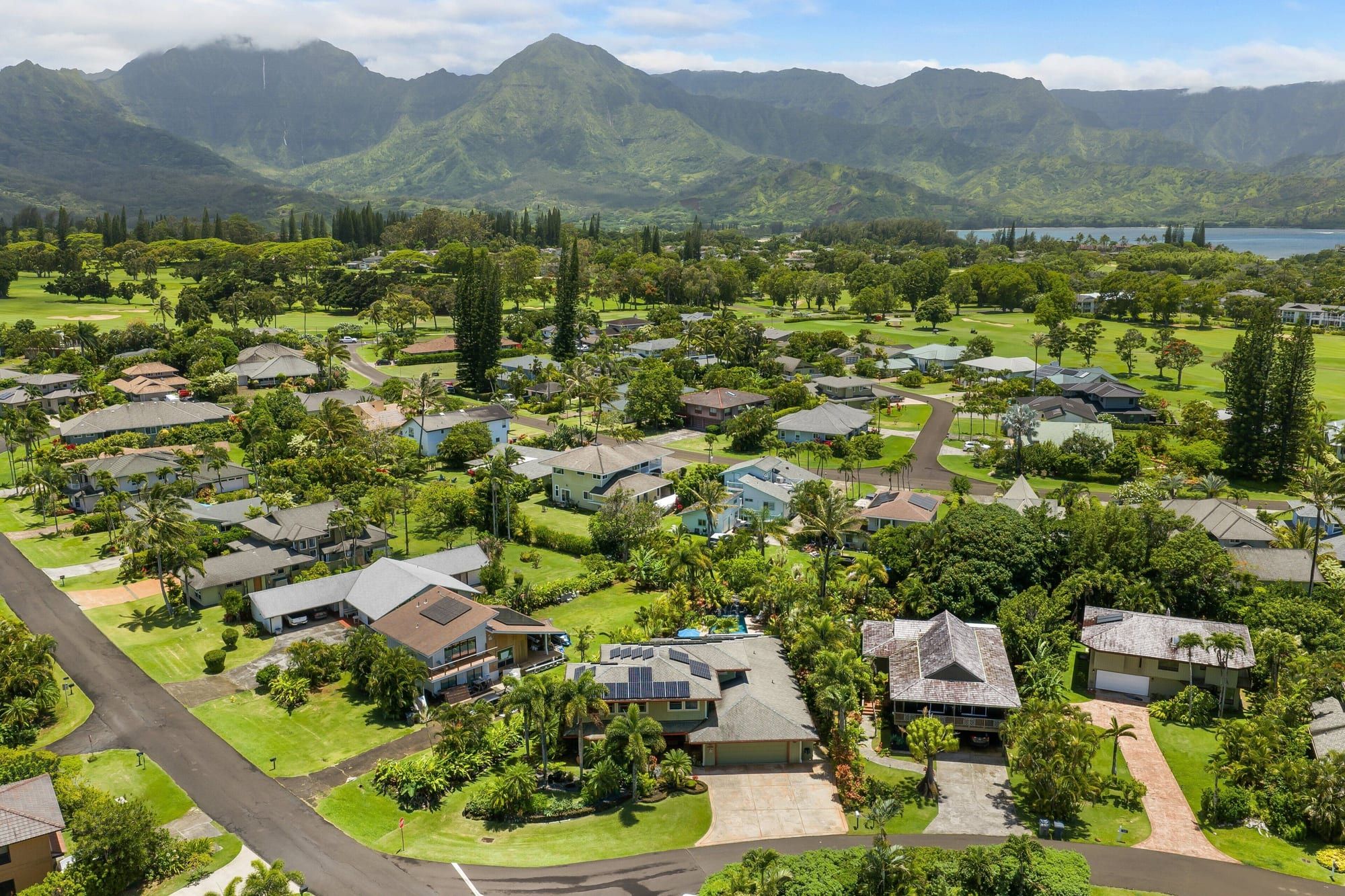 Princeville from above, with Hanalei Bay and green mountains beyond