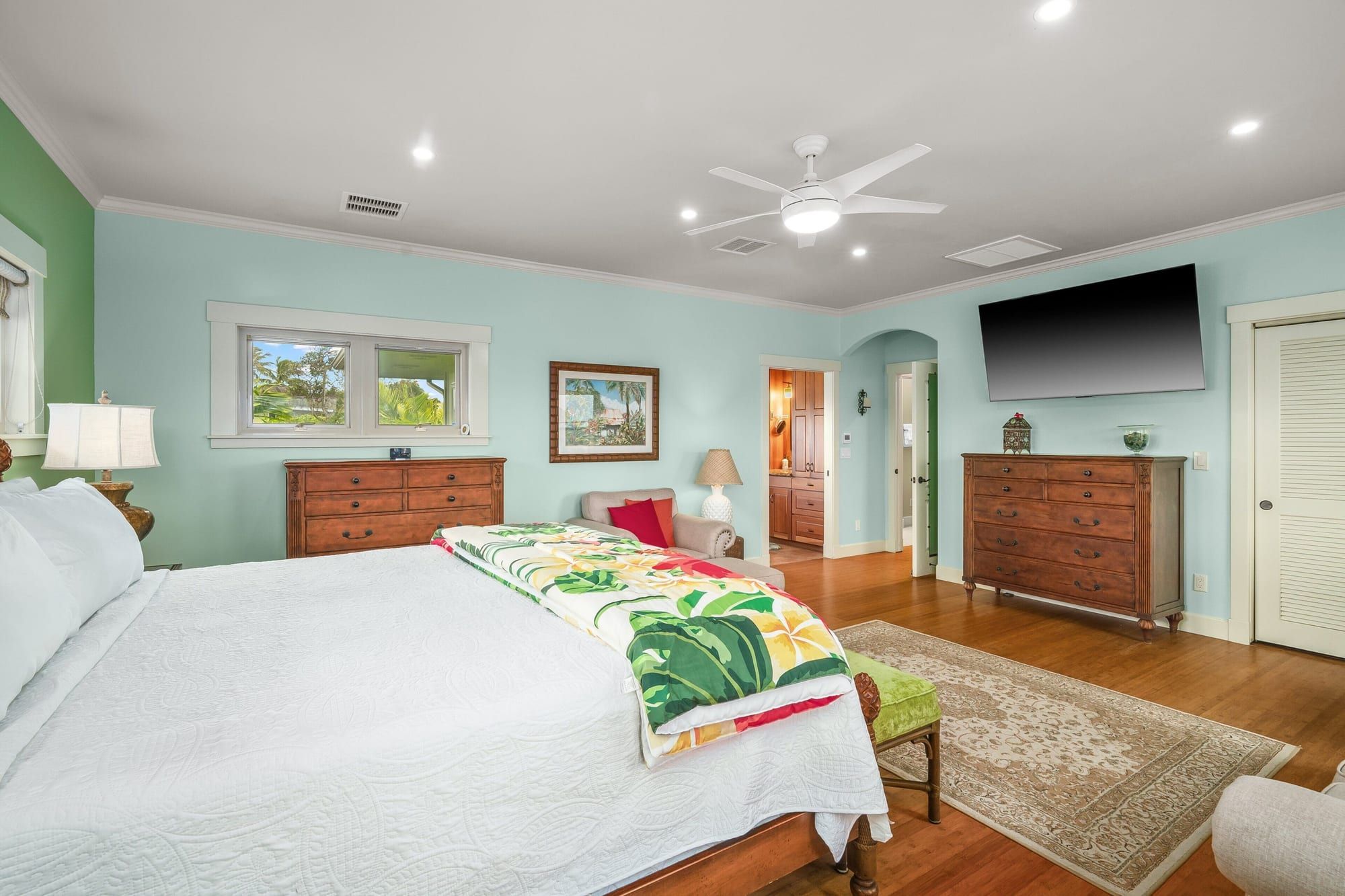 Primary suite with a TV and dressers
