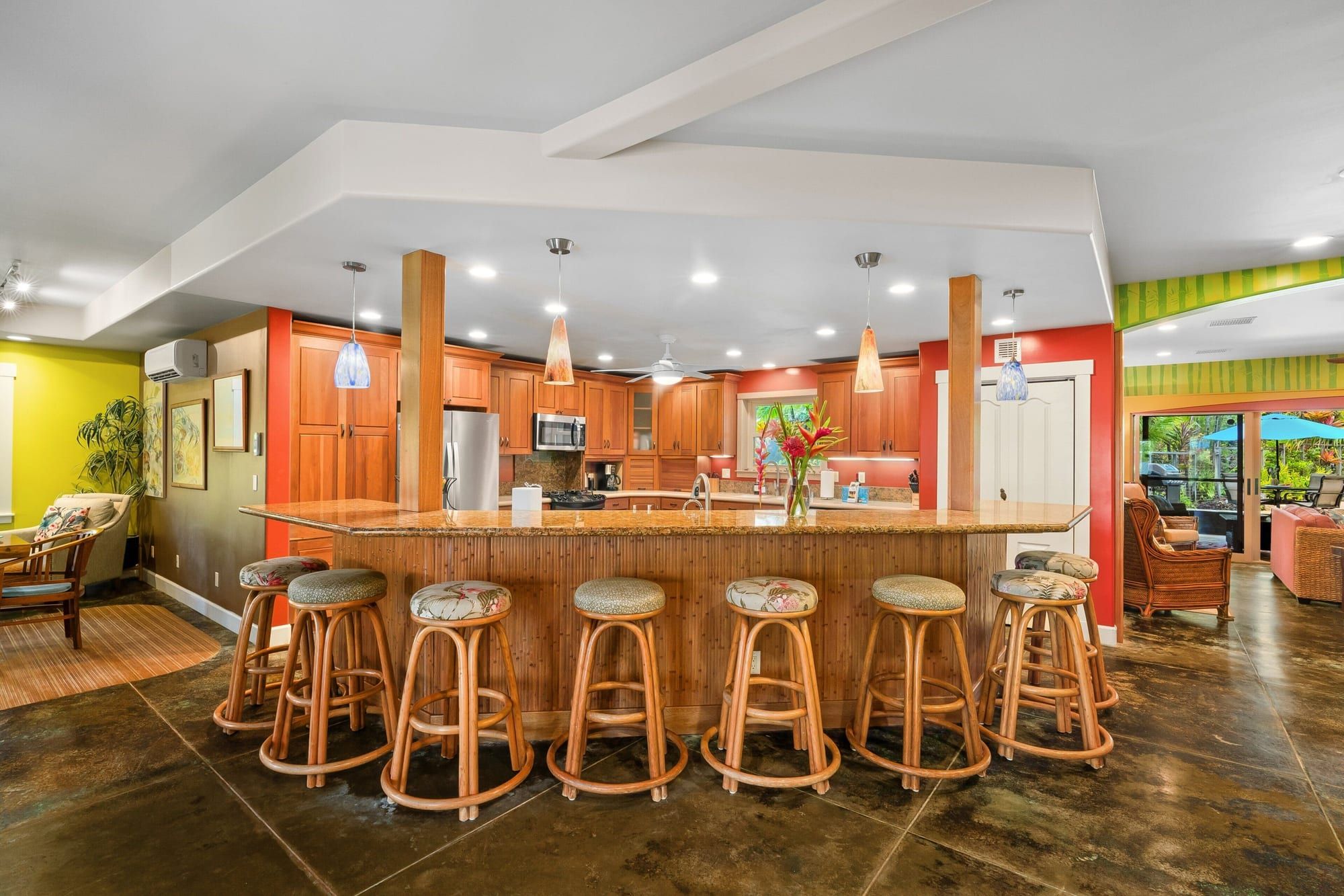 The long kitchen island with seven bar stools